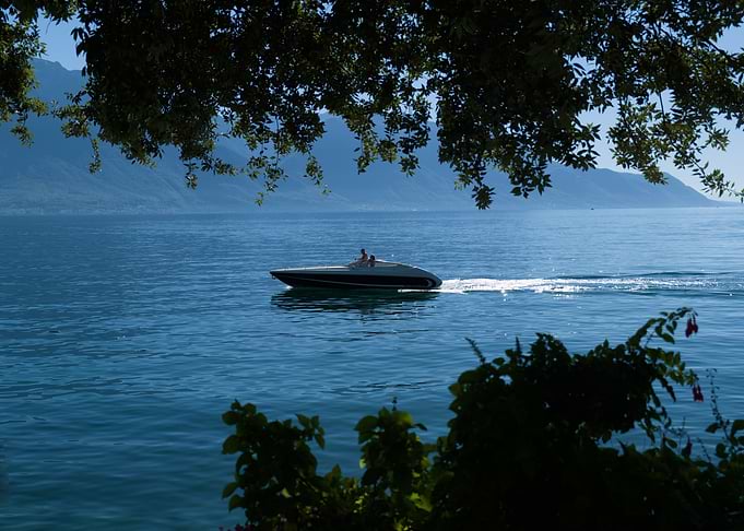 Speedboat cruising on a calm lake Leman