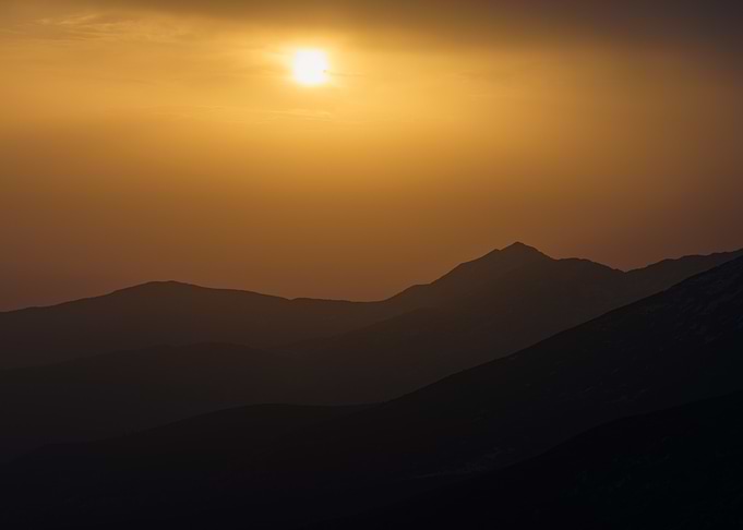 Golden Sunset Over Mountain Silhouettes