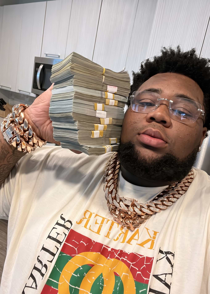 Rod Wave Holding Stack of Cash