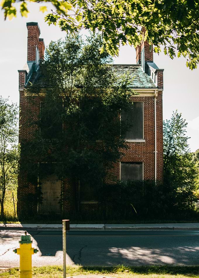 Abandoned Brick Building with Fire Hydrant
