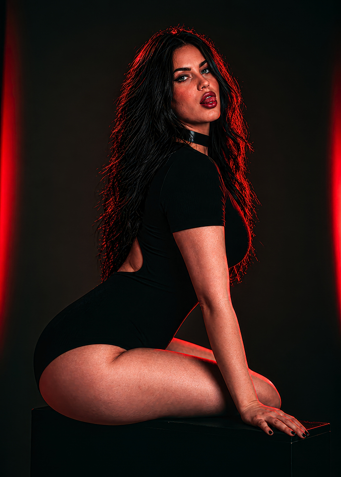 Megan Fox in Black Bodysuit with Red Lighting