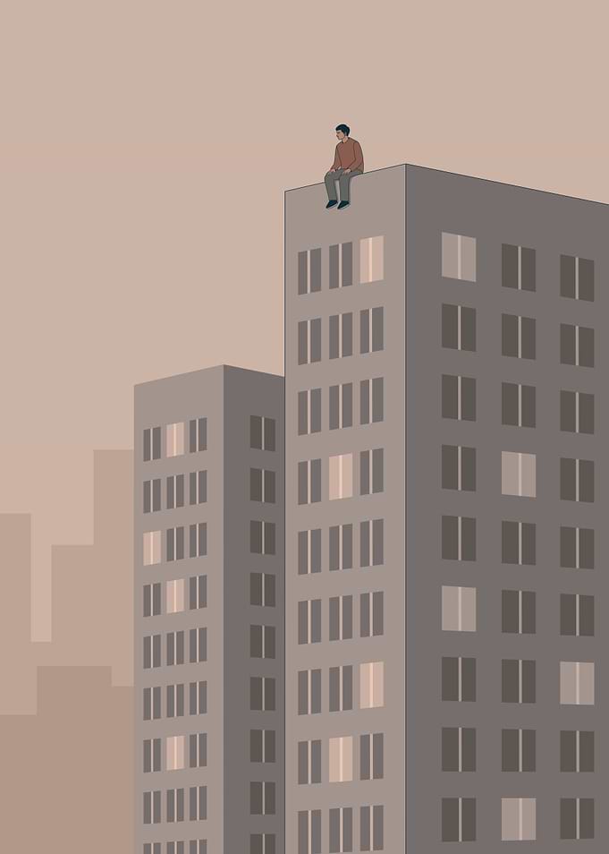 Person sitting on city skyscraper roof