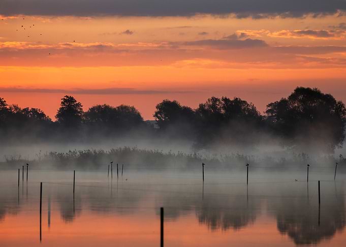 Misty Sunrise Over Calm Lake