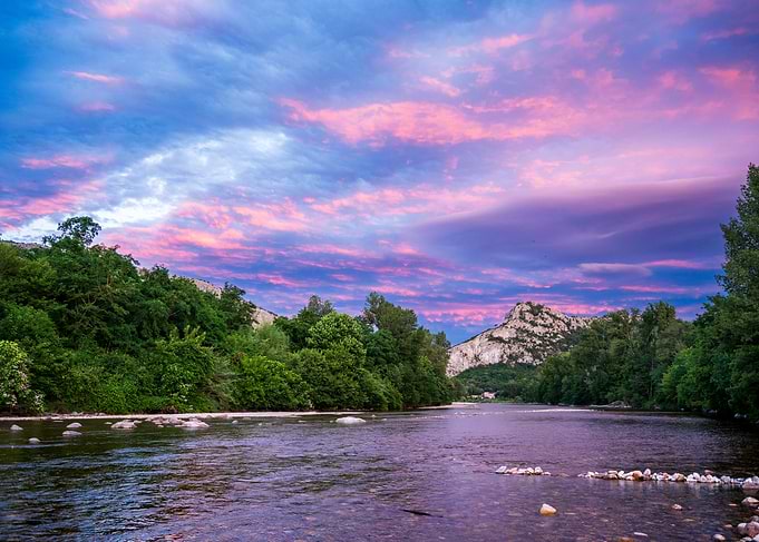 Vibrant Sunset Over River Landscape
