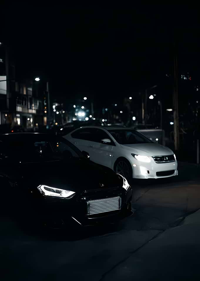 Two Cars Parked at Night