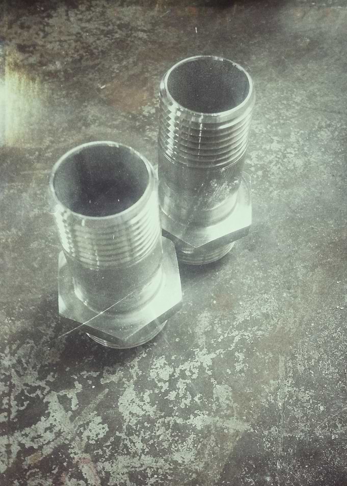 Two Metal Threaded Pipe Fittings