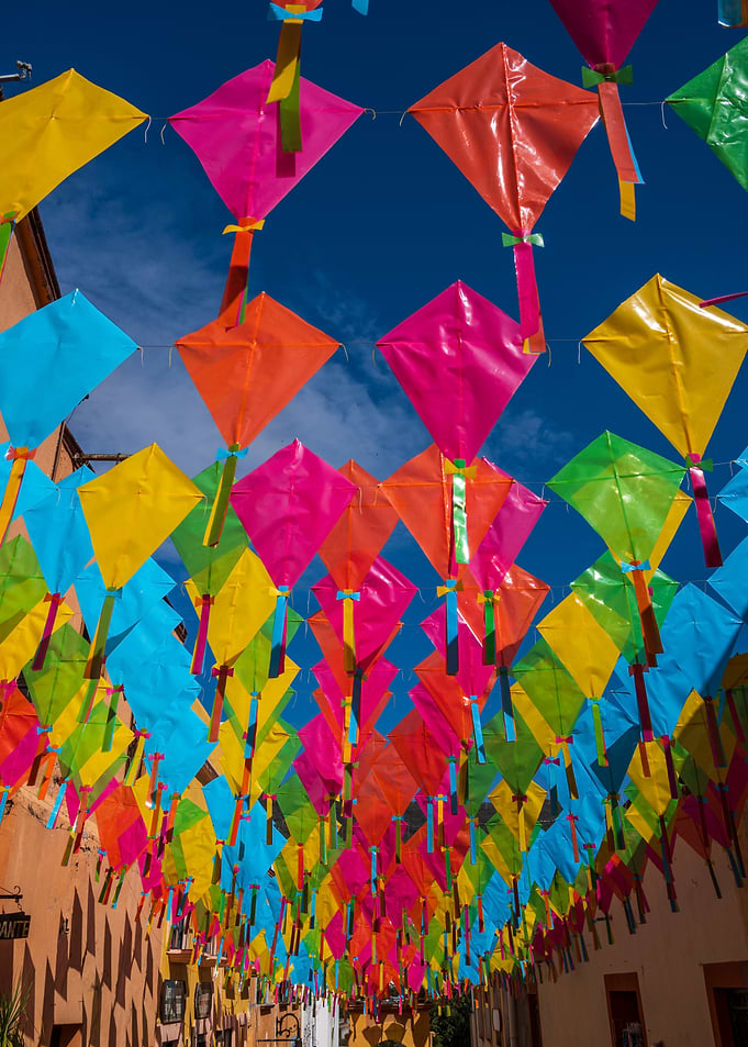 Colorful Kites Hanging Over Street