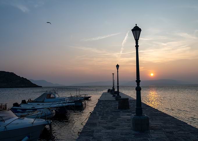 Sunset over a quiet stone pier