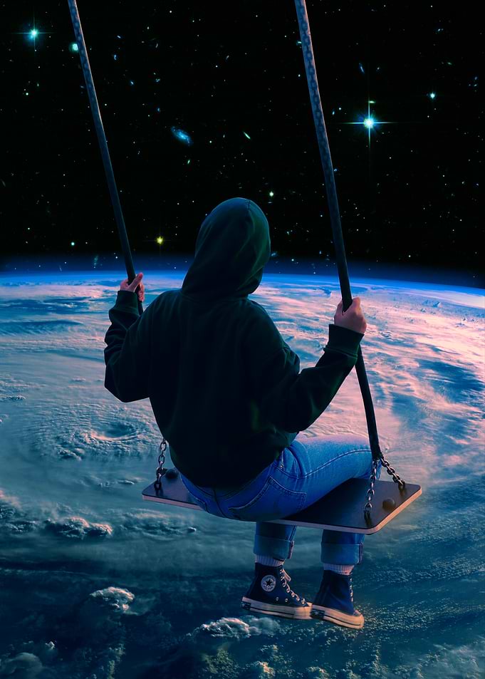 Person Swinging Above Planet Earth
