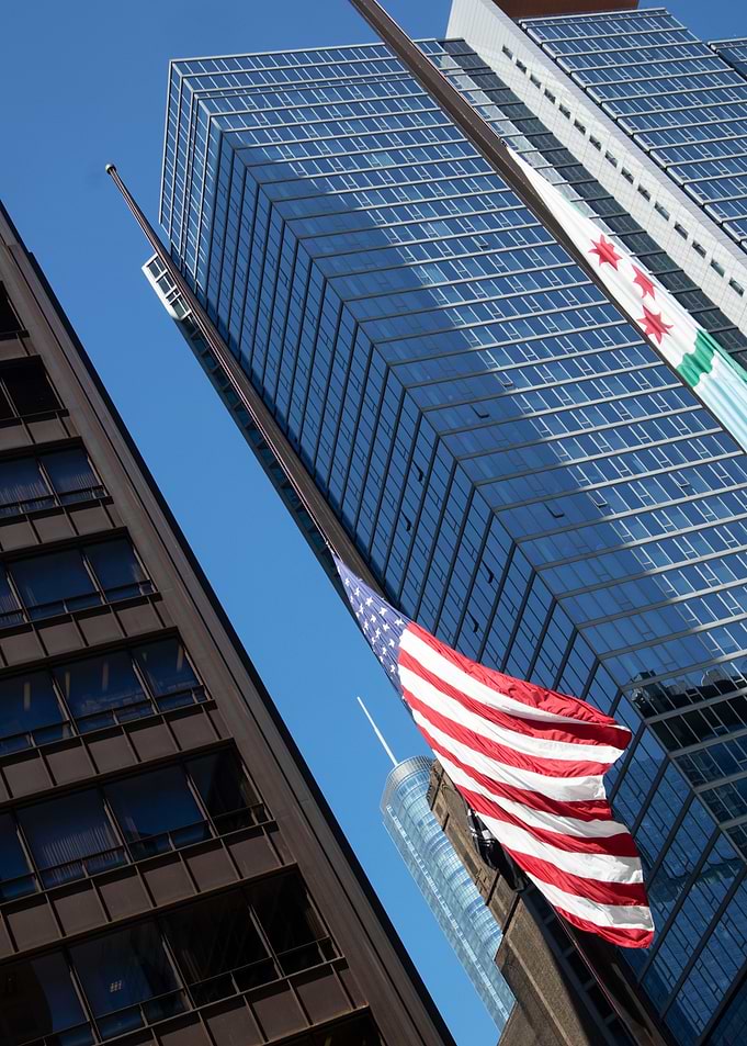 American and Chicago Flags in City