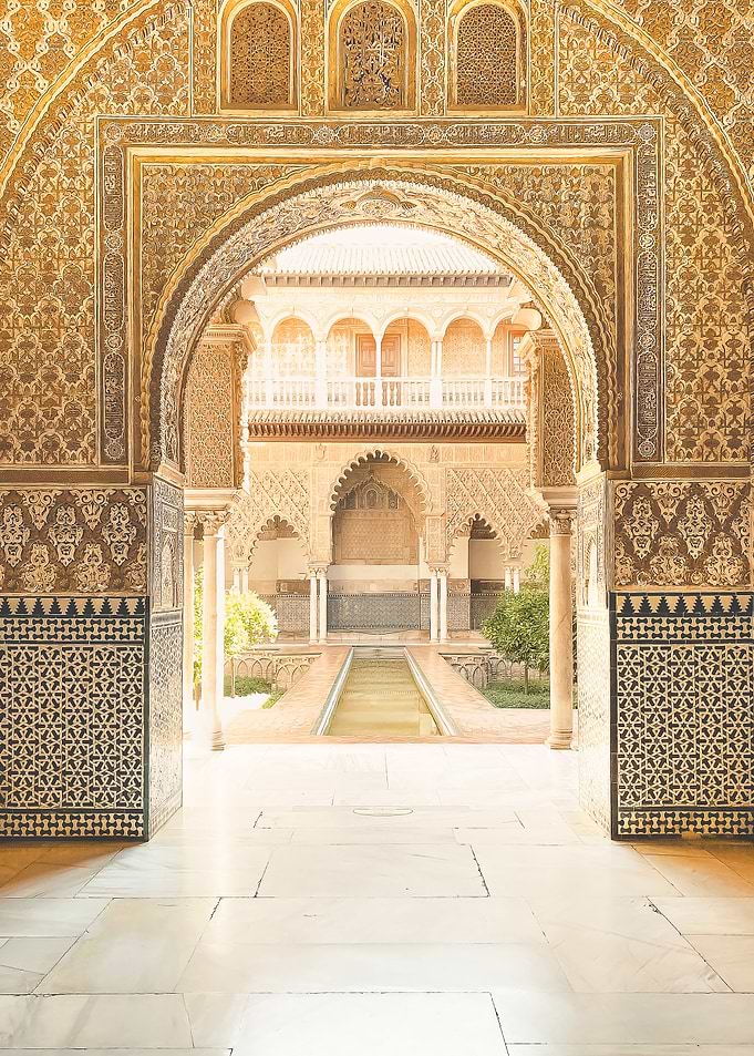 Seville, Spain | Arch of Alcazar Palace or Alhambra of Granada in Mudejar arabesque style and mosaic tilework