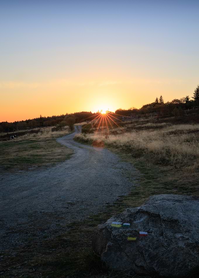 Sunset over a winding mountain trail in Auvergne
