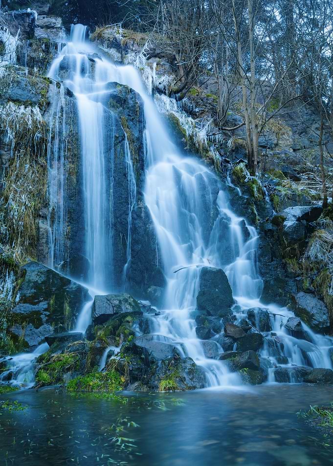 Serene Waterfall in Winter Forest