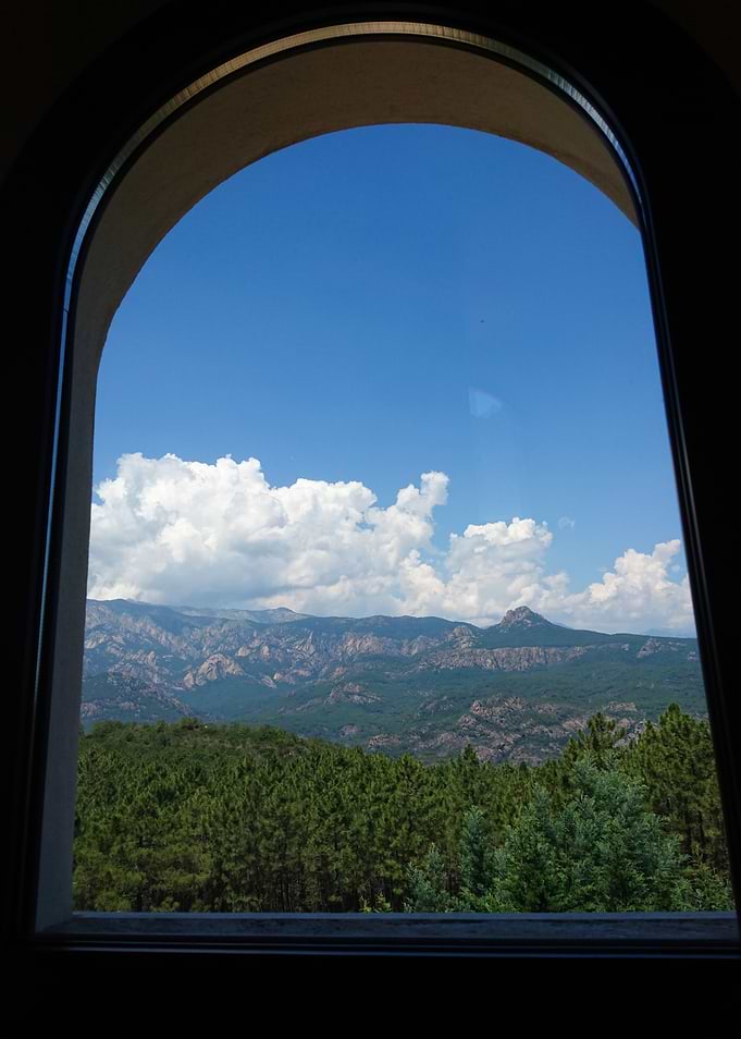 Mountain View Through Arched Window