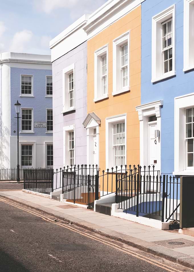 London, England | Pastel facades of Notting Hill with bohemian Victorian architecture in a colorful street