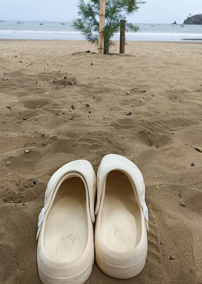 White Clogs on Sandy Beach