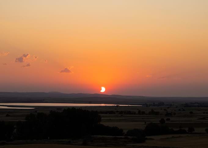 Partial Solar Eclipse Over Landscape