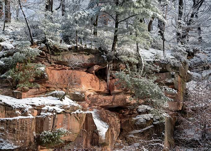 Snow-Covered Red Sandstone Cliff