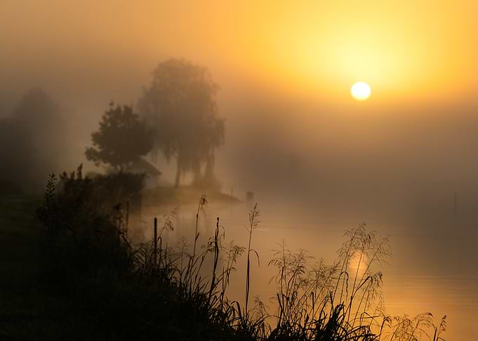 Golden Sunrise Over Misty Lake
