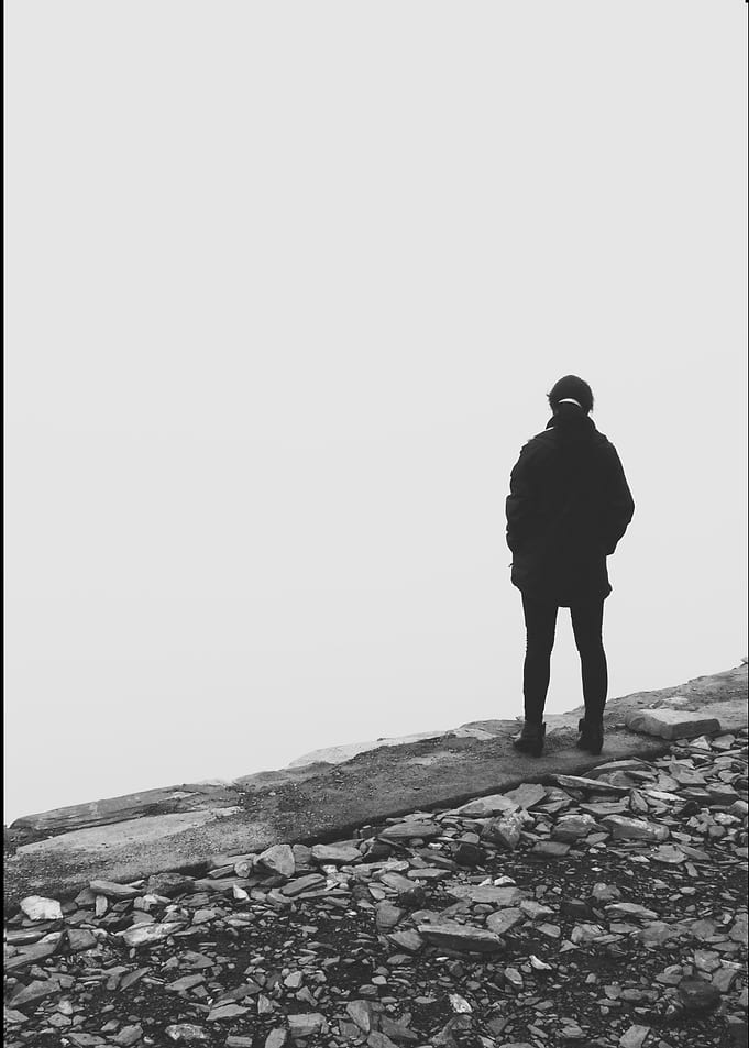 Solitary figure standing in fog
