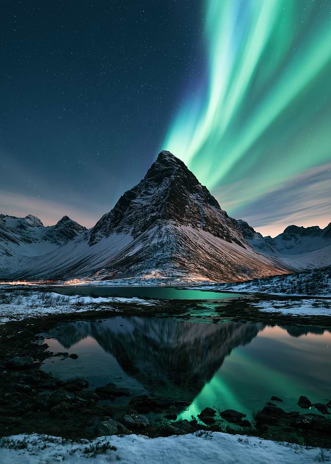 Northern Lights Over Snowy Mountain Peak