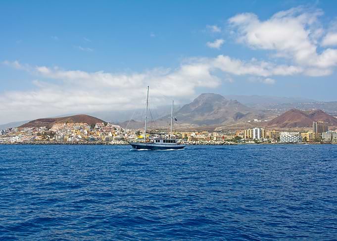 Sailing boat near coastal town
