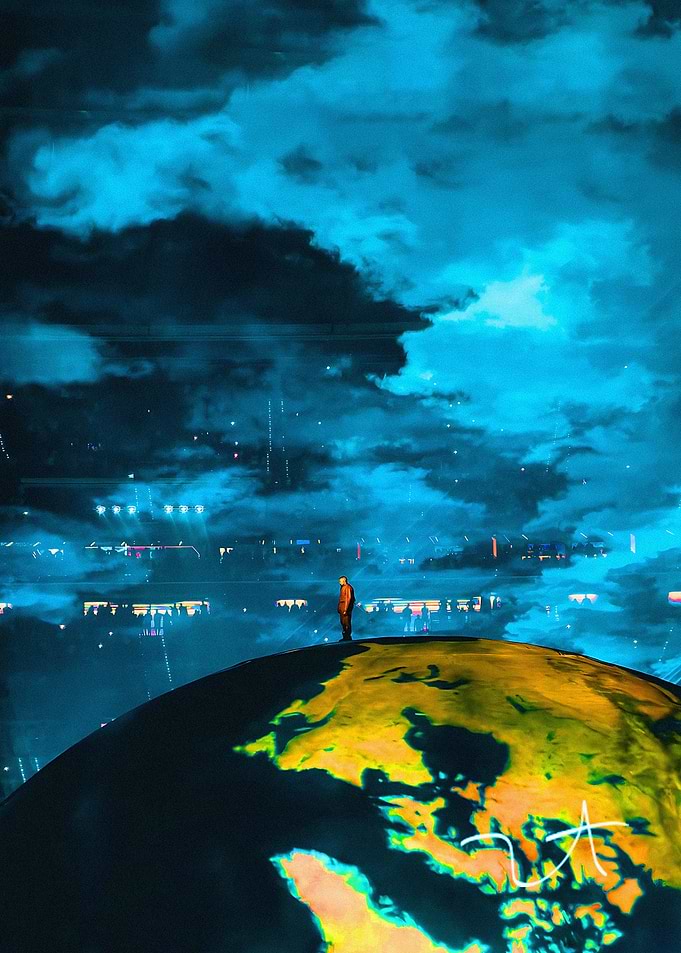 Kanye West Standing on Globe