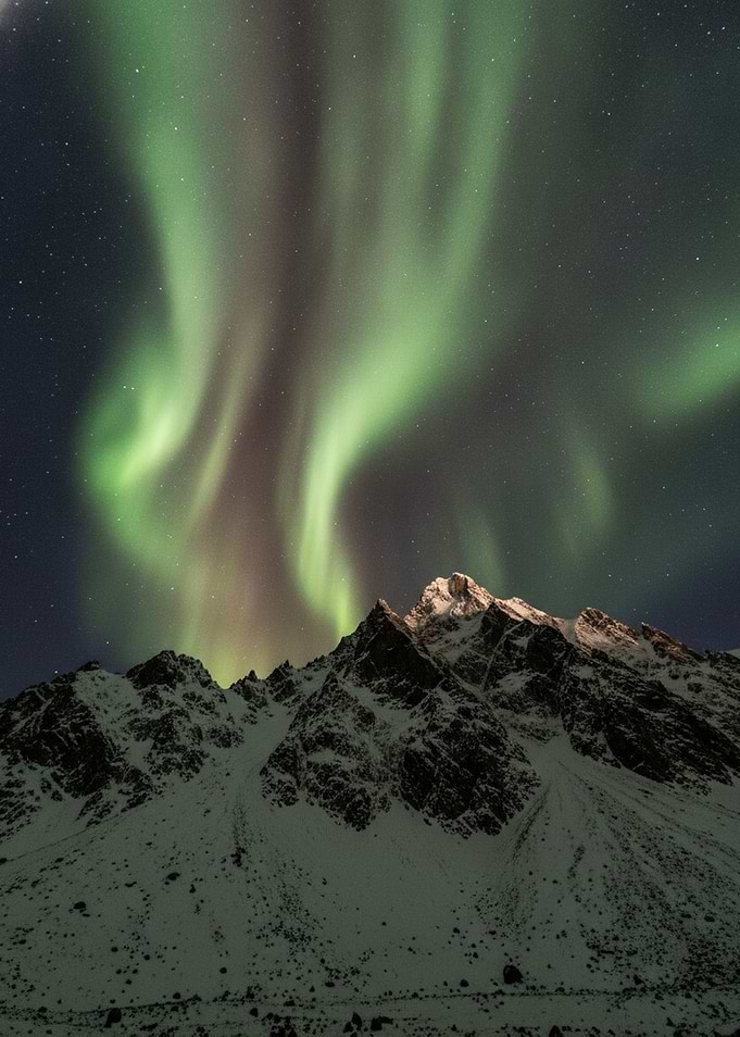 Aurora Borealis Over Snowy Mountains