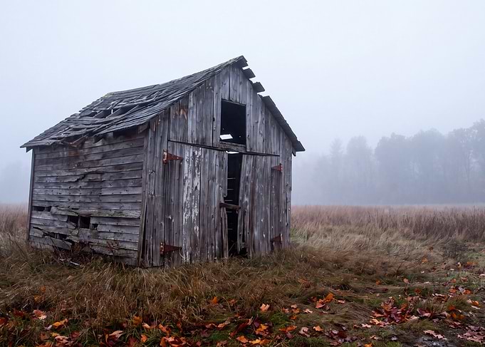 Abandoned Wooden Barn in Fog