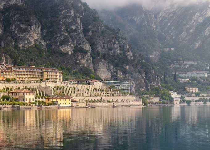 Lakeside Hotel Beneath Mountain Cliffs