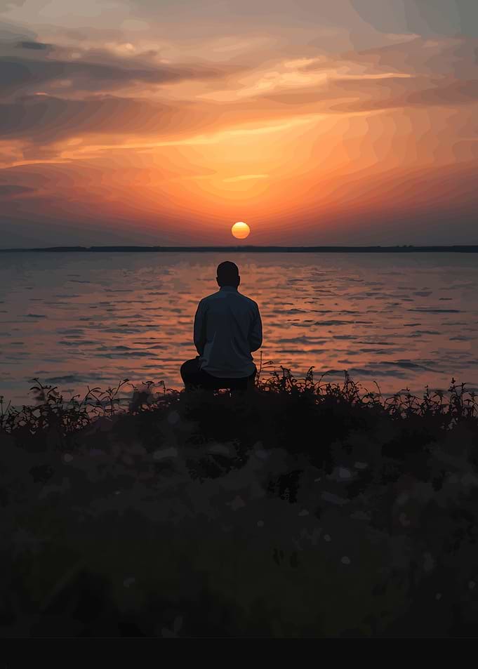 Man Watching Sunset Over Water