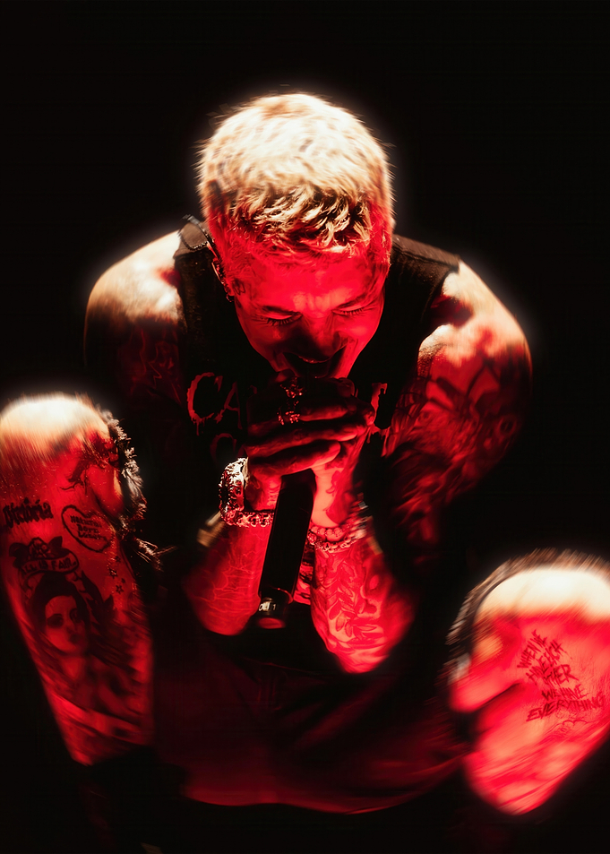 Tattooed Singer Performing Under Red Lights