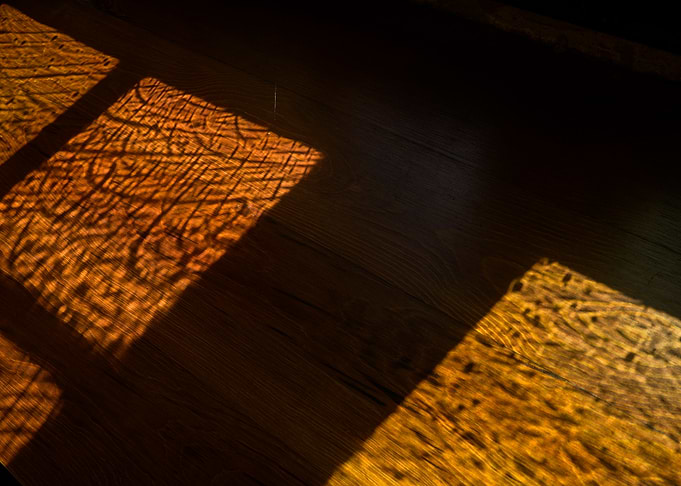Golden Sunlight Patterns on Wooden Floor