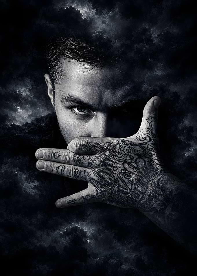 Man with Tattooed Hand and Clouds