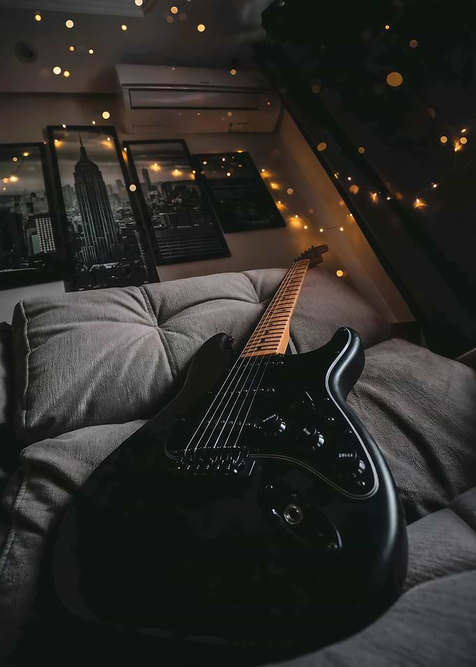 Black Electric Guitar on Sofa