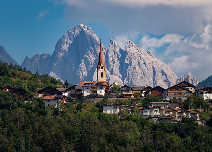 Alpine Village Beneath Jagged Mountains
