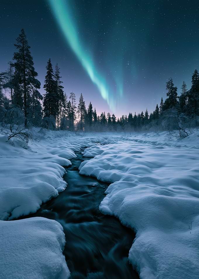 Aurora Borealis Over Snowy Winter Stream