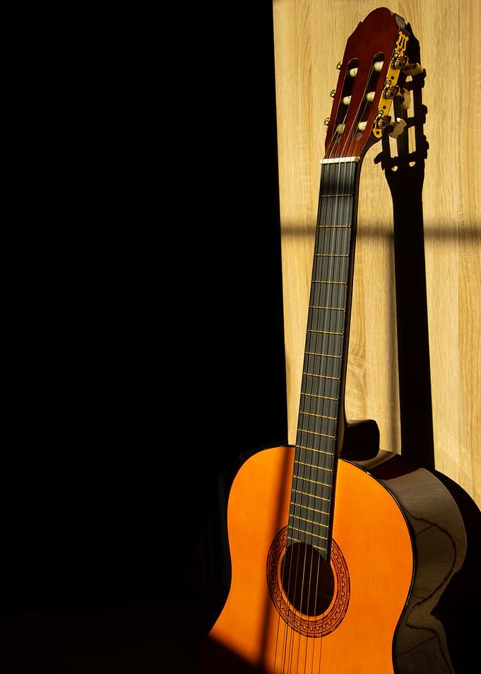 Classical Acoustic Guitar Against Wood
