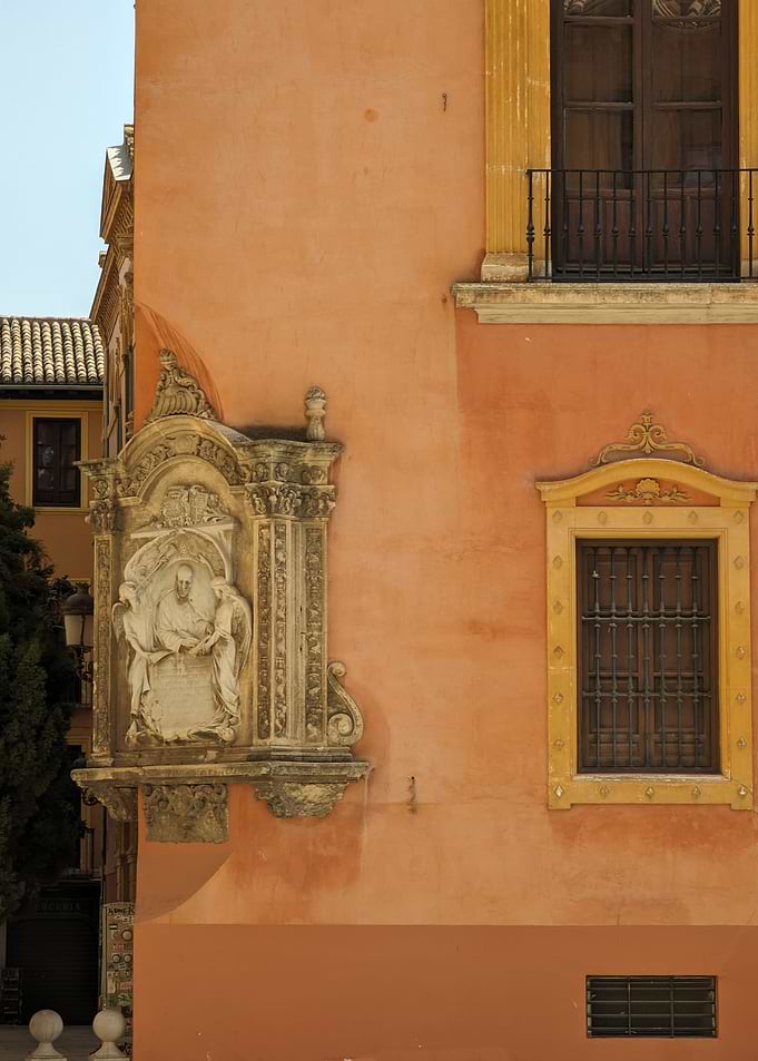 Ornate Stone Relief on Orange Building