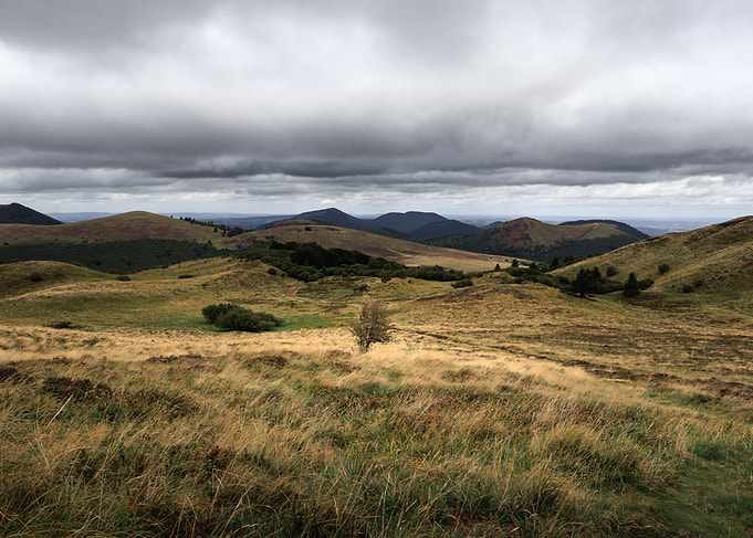 Rolling Hills Under Cloudy Sky