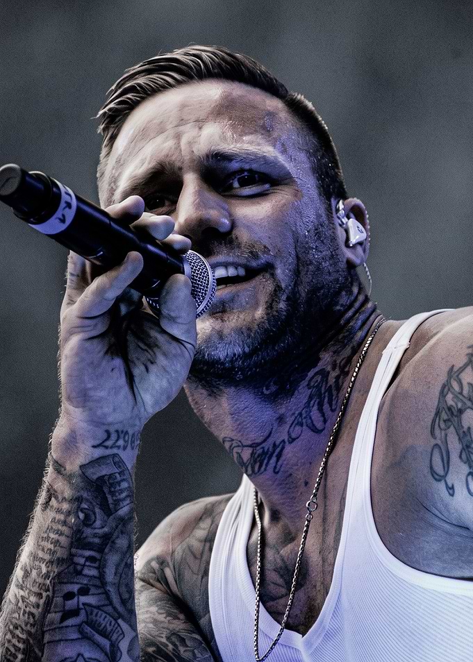 Tattooed Male Singer Performing Live