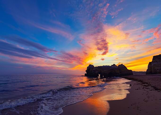 Vibrant Sunset Over Coastal Rock Formations