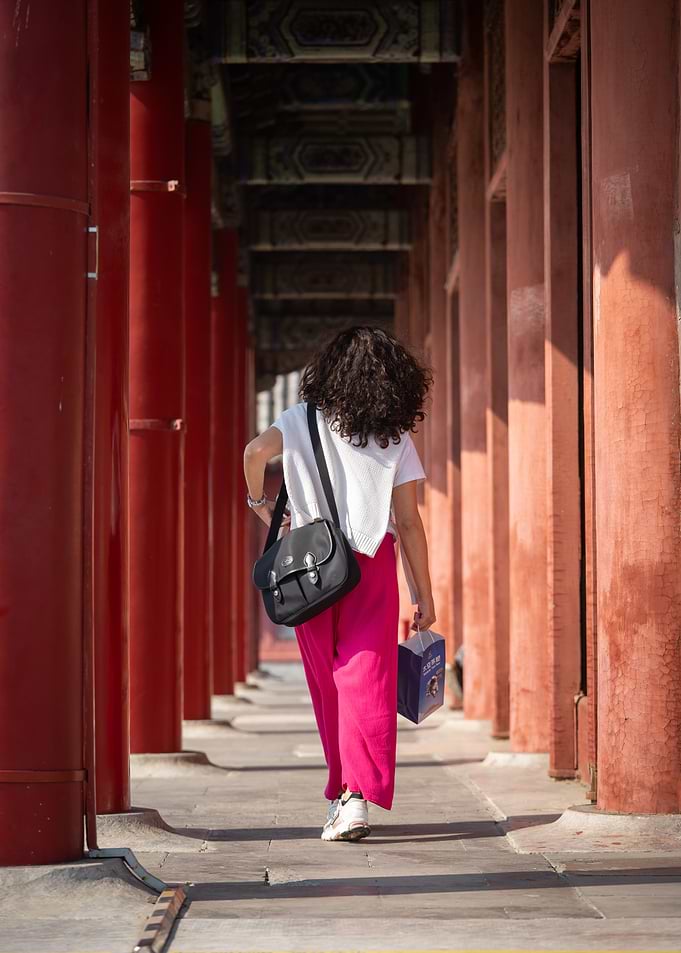 Woman walking through traditional corridor