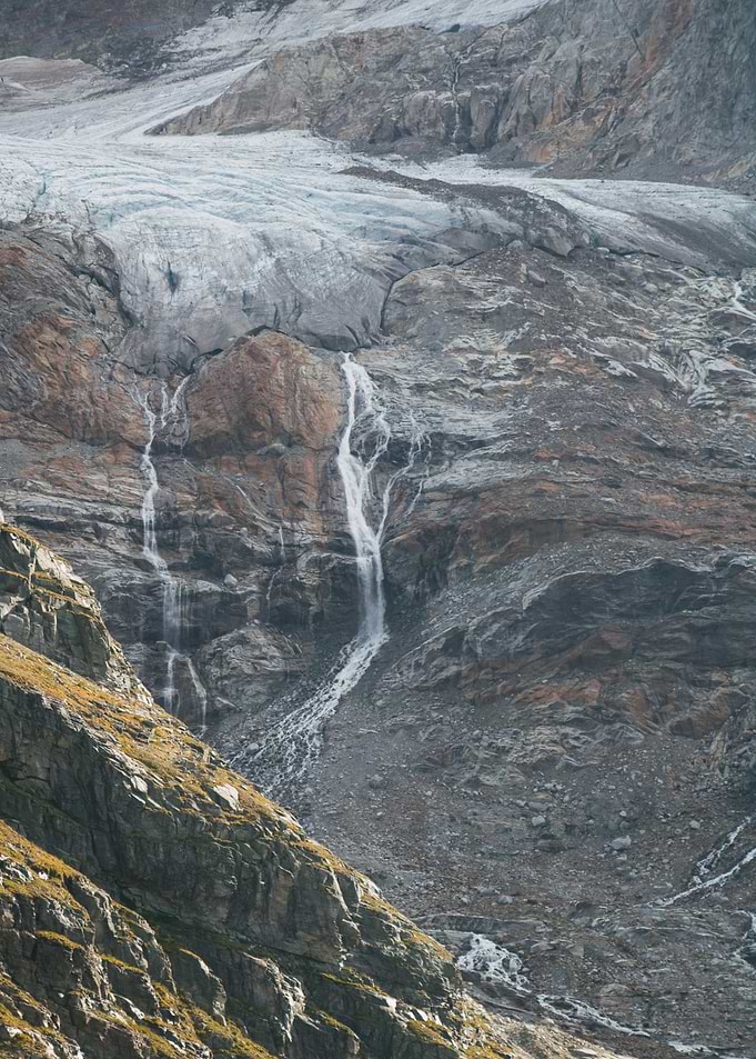 Glacial Waterfall on Rocky Mountain Slope