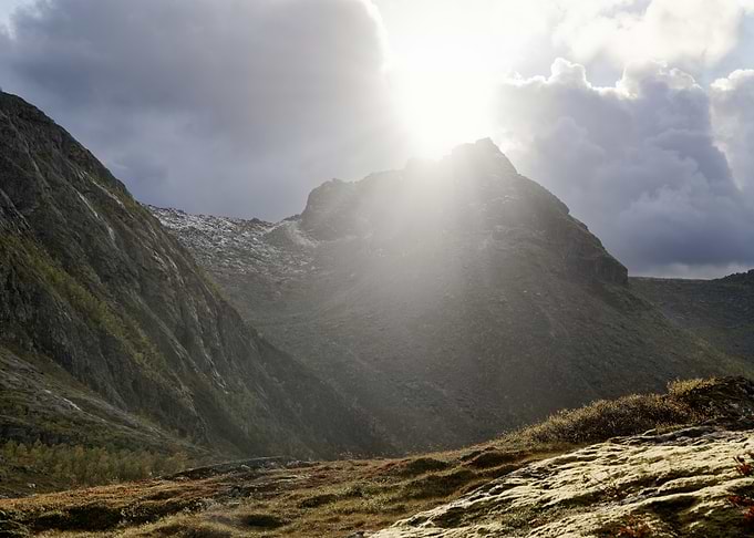 Sunlight Breaking Over Rugged Mountains