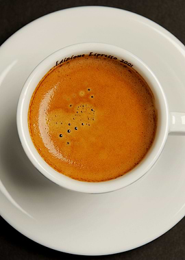 an espresso coffee on dark background photographed from ...