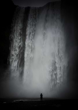 A solitary figure shows the scale of this waterfall in ...
