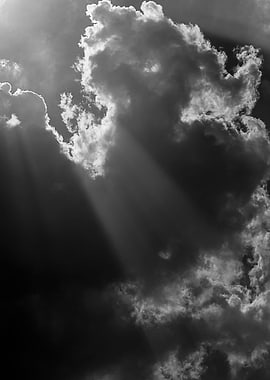 A sunbeam finds its way through the clouds... in black ...