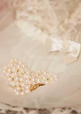 White genuine pearls with 14K gold clasp formed into a ...