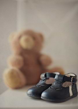 A pair of little shoes on the chair